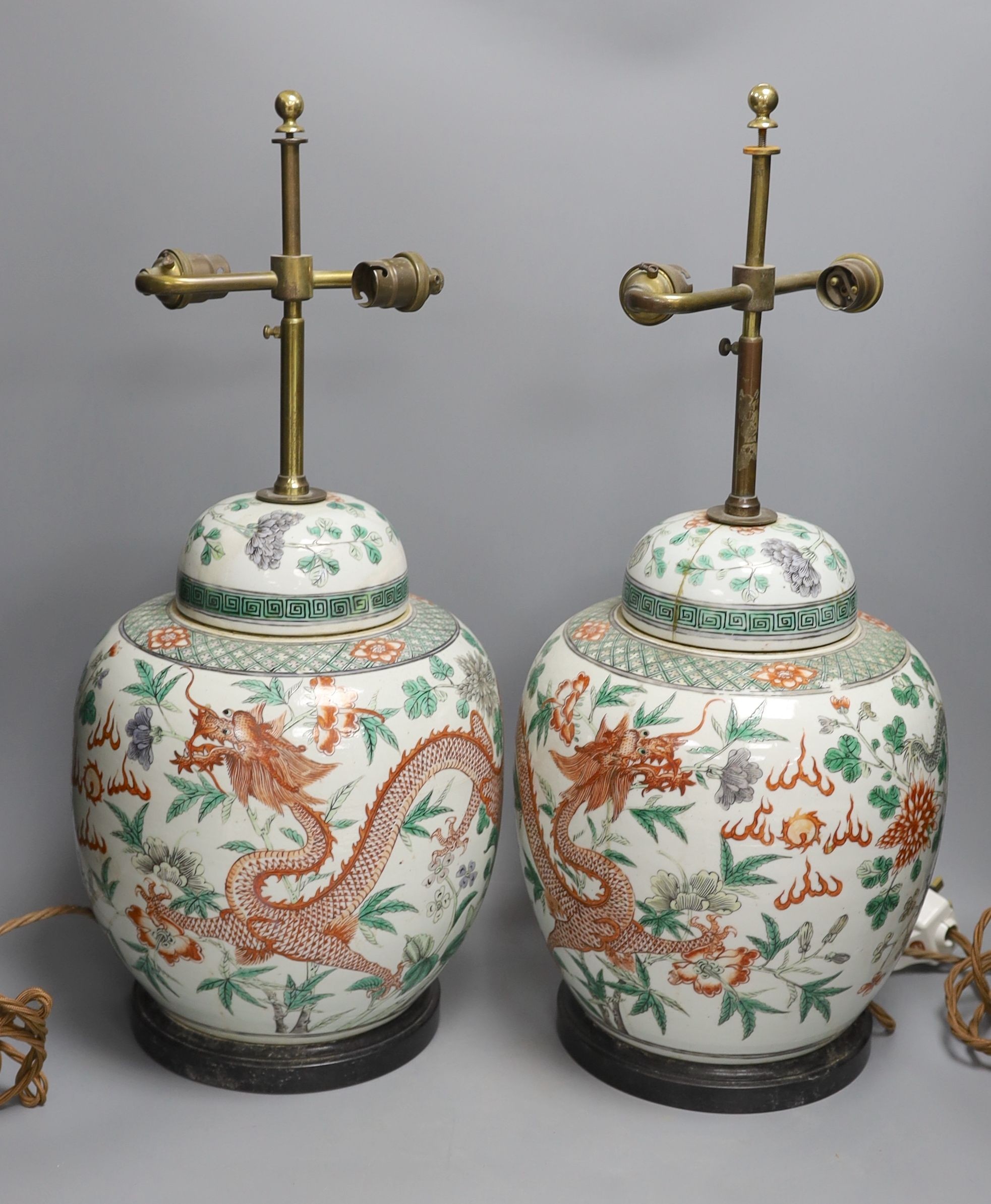 A pair of 19th century Chinese famille verte’dragon’ jars and covers (drilled and converted to lamps) - 53cm high